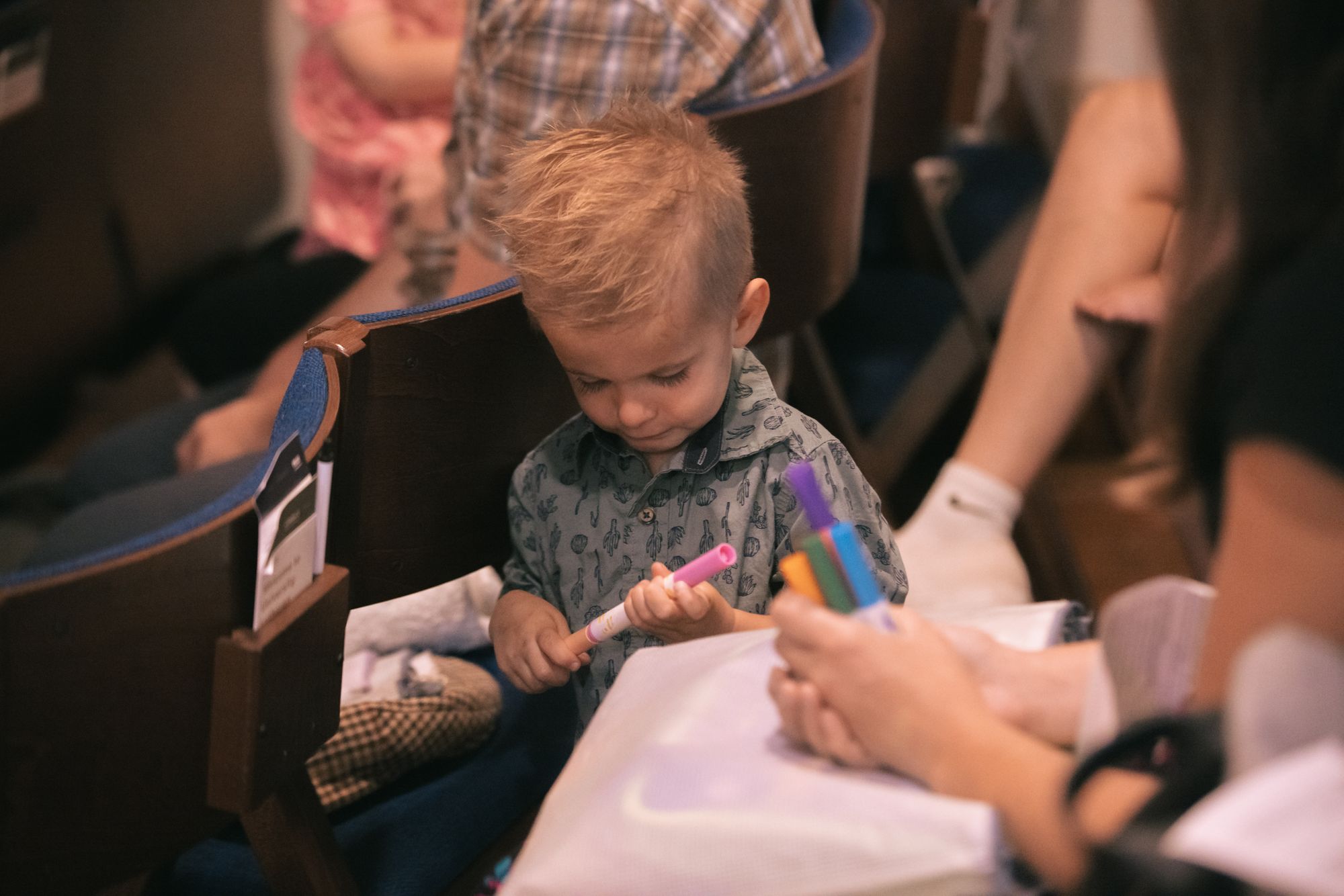 A child coloring during worship