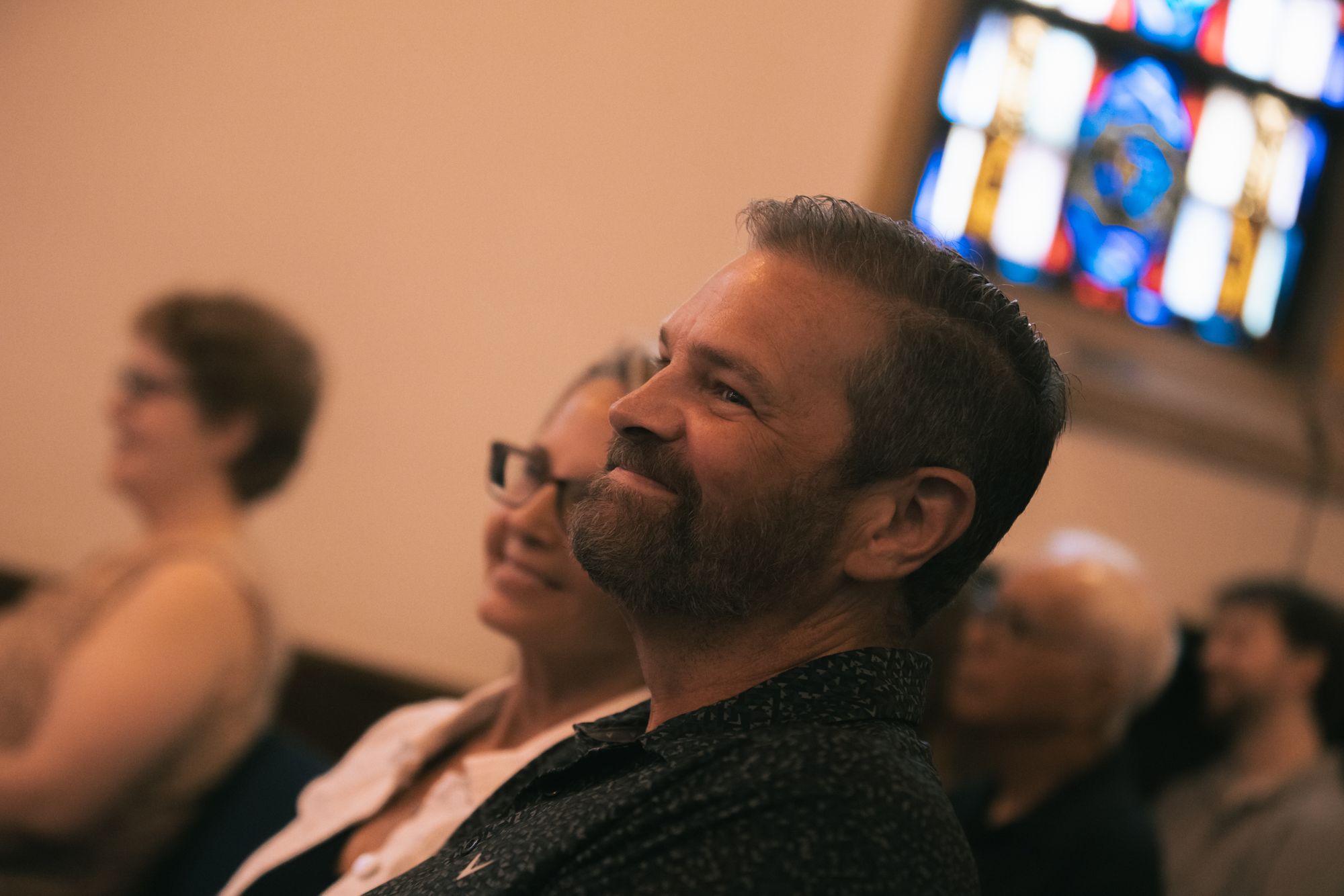 A smiling congregant in the pews